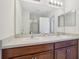 Bathroom with double sink vanity, large mirror, and a view to a walk-in shower at 365 Quarry Rock Cir, Kissimmee, FL 34758