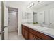 Bathroom featuring double vanity with dark wooden cabinets, and a combination tub/shower at 365 Quarry Rock Cir, Kissimmee, FL 34758