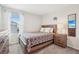 Bedroom with a wooden bed frame, bedside table, and a large window at 365 Quarry Rock Cir, Kissimmee, FL 34758