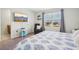 Bright bedroom with blue patterned bedspread, television, and a window view at 365 Quarry Rock Cir, Kissimmee, FL 34758