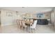 Elegant dining room with seating for eight, tile floors, and a view into the living area at 365 Quarry Rock Cir, Kissimmee, FL 34758