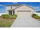 Charming two-story home with a two-car garage, landscaped yard, and a welcoming front porch at 365 Quarry Rock Cir, Kissimmee, FL 34758