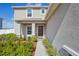Charming two-story home featuring a stylish front door, complemented by attractive landscaping and a welcoming walkway at 365 Quarry Rock Cir, Kissimmee, FL 34758