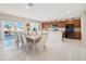 Open-concept kitchen and dining room with stainless steel appliances and a large island at 365 Quarry Rock Cir, Kissimmee, FL 34758
