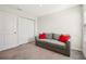 Living room featuring a gray sofa with red pillows and a large closet with sliding doors at 365 Quarry Rock Cir, Kissimmee, FL 34758
