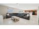 Open-concept living area with tile floors and a spacious seating area leading into the kitchen at 365 Quarry Rock Cir, Kissimmee, FL 34758