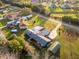 An aerial view of a home with solar panels, a screened pool, and mature trees at 38934 Sulen Rd, Lady Lake, FL 32159
