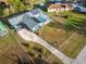 Aerial view of a home showcasing solar panels, a screened-in pool, and a spacious yard at 38934 Sulen Rd, Lady Lake, FL 32159