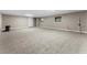 Spacious basement with neutral carpeting, plenty of electrical outlets, and a door to the outside at 38934 Sulen Rd, Lady Lake, FL 32159