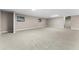 Large basement with neutral colored carpet, windows for natural light, and stairs to the upper floor at 38934 Sulen Rd, Lady Lake, FL 32159