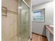 Bathroom showcasing walk-in shower and natural light, with a tiled shower and wooden floor at 38934 Sulen Rd, Lady Lake, FL 32159