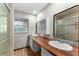 Bathroom with solid-surface countertops, dual sinks, vanity with storage, tile surround and shower at 38934 Sulen Rd, Lady Lake, FL 32159