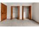 This spacious bedroom features neutral carpet and trim, with two walk-in closets and paneled door at 38934 Sulen Rd, Lady Lake, FL 32159