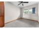 Bedroom has a ceiling fan, window, carpeted floor and a closet with louvered wood doors at 38934 Sulen Rd, Lady Lake, FL 32159