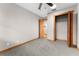 Bedroom featuring light grey carpet, a ceiling fan, and a closet with wood door at 38934 Sulen Rd, Lady Lake, FL 32159