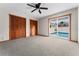Bedroom has light grey carpet and sliding glass doors with view of swimming pool at 38934 Sulen Rd, Lady Lake, FL 32159