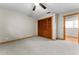 Bedroom featuring a ceiling fan, light grey carpet, wood trim, and wood closet doors at 38934 Sulen Rd, Lady Lake, FL 32159