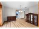 Dining room with wood floors and wood accents leads to kitchen with blue cabinetry at 38934 Sulen Rd, Lady Lake, FL 32159