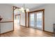 Dining area featuring light wood floors, wood trim, and a chandelier above French doors at 38934 Sulen Rd, Lady Lake, FL 32159