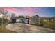 Charming single-story home with a mix of brick and siding under a colorful sky at 38934 Sulen Rd, Lady Lake, FL 32159