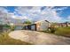 Exterior view of home with long driveway, blue paint, and front-facing garage at 38934 Sulen Rd, Lady Lake, FL 32159