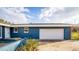 Attached two-car garage featuring a spacious driveway and manicured lawn, providing ample parking at 38934 Sulen Rd, Lady Lake, FL 32159