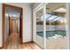 Hallway view of the screened-in pool visible through the glass sliding door at 38934 Sulen Rd, Lady Lake, FL 32159