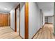 Hallway has hardwood floors and wood trim featuring doorways to other rooms at 38934 Sulen Rd, Lady Lake, FL 32159