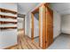 Hallway features natural wood floors, doors, and trim leading to carpeted rooms and built-in shelving at 38934 Sulen Rd, Lady Lake, FL 32159