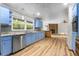 Bright kitchen with blue cabinets, granite countertops, and stainless steel appliances at 38934 Sulen Rd, Lady Lake, FL 32159