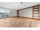Bright living room featuring stylish wood floors, built-in shelving, and a large window at 38934 Sulen Rd, Lady Lake, FL 32159