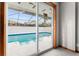 View of the pool through a sliding glass door; pool has a screened enclosure at 38934 Sulen Rd, Lady Lake, FL 32159