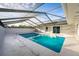 Enclosed pool area with cool blue water, deck, and sliding door entrance at 38934 Sulen Rd, Lady Lake, FL 32159
