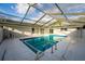 Enclosed pool area with cool blue water, deck, and sliding door entrance at 38934 Sulen Rd, Lady Lake, FL 32159