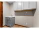 A utility sink with vanity and overhead cabinets, and contrasting wood trim in the background at 38934 Sulen Rd, Lady Lake, FL 32159