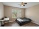 Bedroom with a ceiling fan, wood-look floors, natural light and a view of the trees at 4273 Northern Dancer Way, Orlando, FL 32826