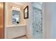 White bathroom featuring mirror and an adjacent shower at 4754 E Wind St, Orlando, FL 32812