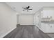 Bright living area featuring gray flooring, ceiling fan, and glass doors leading outside at 4835 Bennington Pl, Orlando, FL 32808