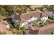 Overhead view of a complex of townhomes with landscaping and a mix of roofs and trees at 5354 Diplomat Ct # 106, Kissimmee, FL 34746
