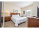 Bright bedroom with a plush bed, matching nightstands, and charming lamps for a relaxing ambiance at 5354 Diplomat Ct # 106, Kissimmee, FL 34746