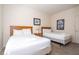 Comfortable bedroom has two beds, nightstand and carpeted floors for a cozy feel at 5354 Diplomat Ct # 106, Kissimmee, FL 34746
