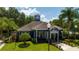 Charming blue clubhouse with manicured landscaping, offering a welcoming community space at 5354 Diplomat Ct # 106, Kissimmee, FL 34746