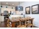 Cozy dining area featuring a wooden table, wicker chairs, and a modern pendant light at 5354 Diplomat Ct # 106, Kissimmee, FL 34746