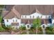 Aerial view of light blue townhomes with brown shutters and roofs surrounded by sidewalks and green landscaping at 5354 Diplomat Ct # 106, Kissimmee, FL 34746