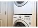 Close-up of the modern, stacked washer and dryer units at 5354 Diplomat Ct # 106, Kissimmee, FL 34746