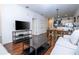 Open-concept living space with a neutral color palette, hardwood floors, and views into the kitchen at 5354 Diplomat Ct # 106, Kissimmee, FL 34746