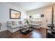Bright and airy living room featuring modern decor, a large mirror, and hardwood floors at 5354 Diplomat Ct # 106, Kissimmee, FL 34746