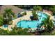 Aerial view of a resort-style pool with palm trees, lounge chairs, and a splash area at 5354 Diplomat Ct # 106, Kissimmee, FL 34746
