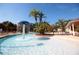 Inviting community pool with palm trees, splash fountain, and ample lounging space, perfect for relaxation at 5354 Diplomat Ct # 106, Kissimmee, FL 34746