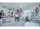 Unique hobby bedroom features a white ceiling fan, and shelving decorated with action figures at 5430 Pine Lilly Dr, St Cloud, FL 34771